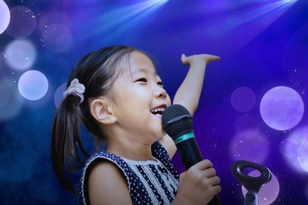 Child sings on stage for a talent competition
